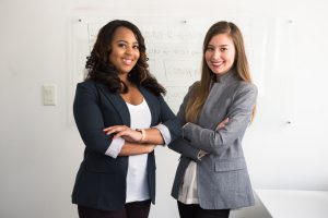 An executive female team smiling in a boardroom