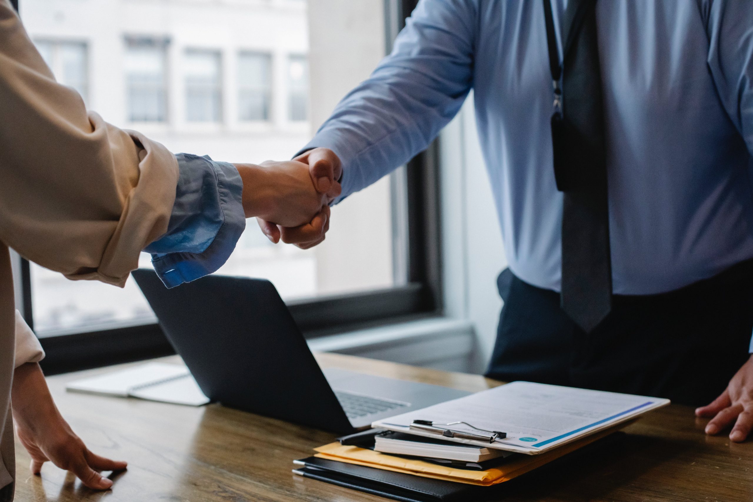 Executive headhunter shaking hands in office