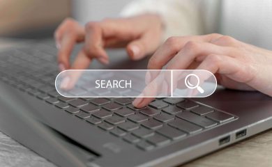 Woman typing on a laptop keyboard to conduct an executive search in South Africa