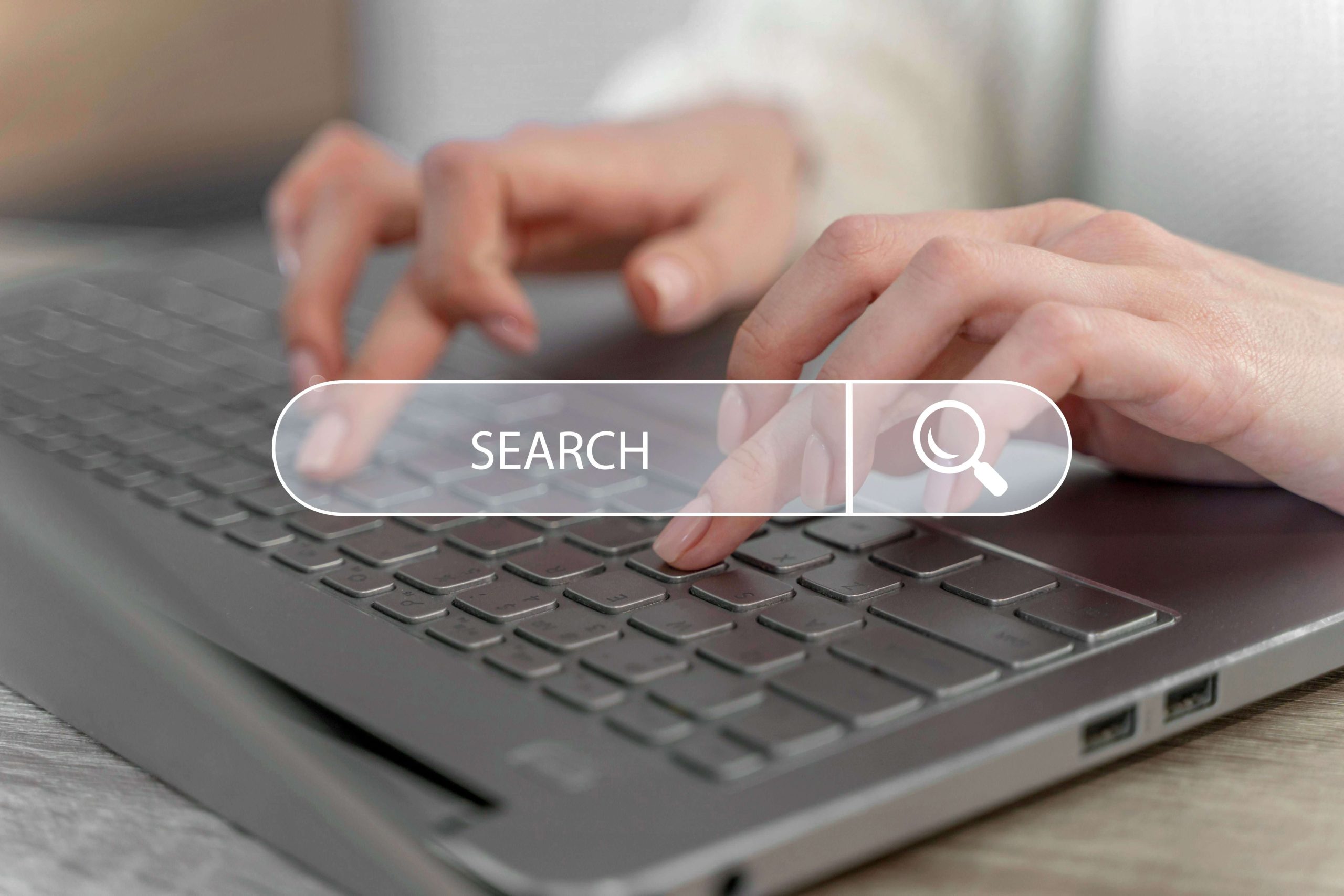 Woman typing on a laptop keyboard to conduct an executive search in South Africa